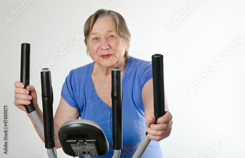Photo: Senior woman on training bicycle Senior woman on training bicycle