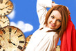 Фото: beautiful girl on clocks and blue sky background beautiful girl on clocks and blue sky background