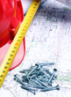 Architectural drawings, red helmet, measure and screws