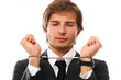 Handsome businessman hands in handcuffs