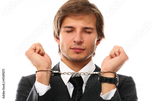 Photo: Handsome businessman hands in handcuffs Handsome businessman hands in handcuffs