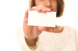 Photo: Young smiling woman holding blank paper Young smiling woman holding blank paper