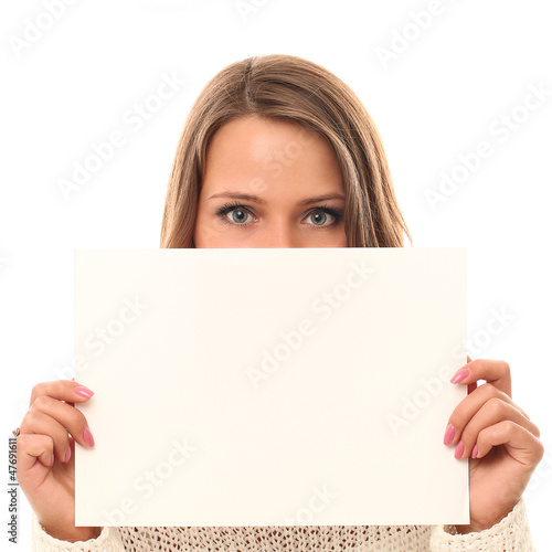 Photo: Young smiling woman holding blank paper Young smiling woman holding blank paper