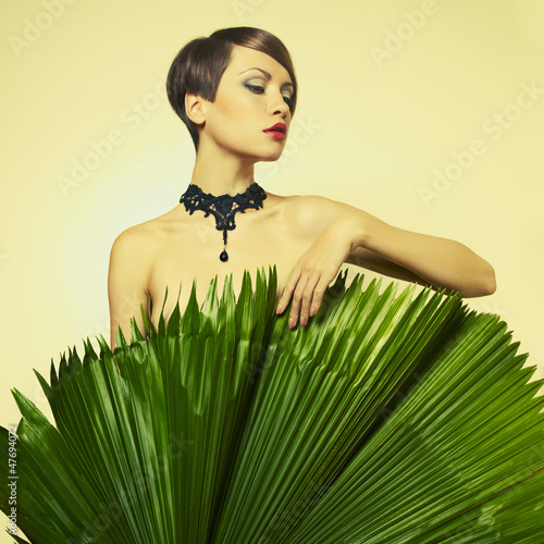 Photo: Beautiful lady with palm leaves Beautiful lady with palm leaves