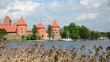 People rest near Trakai castle. Zorb bubble water bicycle lake