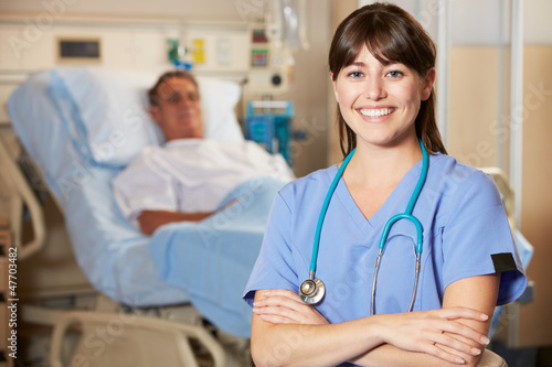 Photo: Portrait Of Nurse With Patient In Background Portrait Of Nurse With Patient In Background