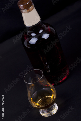 Photo: whisky on a black background whisky on a black background