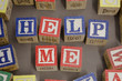 Play Blocks. Letters that spell "help me".