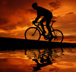 Photo: silhouette of the cyclist riding a road bike silhouette of the cyclist riding a road bike