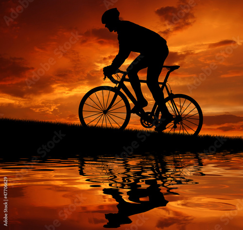 Photo: silhouette of the cyclist riding a road bike silhouette of the cyclist riding a road bike
