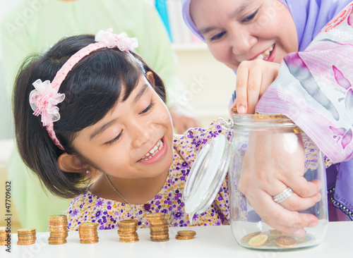 Photo: Muslim saving money concept Muslim saving money concept
