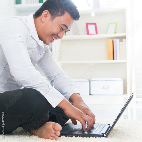 Photo: Asian man surfing internet Asian man surfing internet