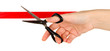 Cutting red ribbon isolated on white