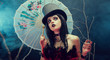 Attractive gothic girl in top hat with Chinese umbrella looking