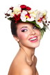beautiful woman with bright makeup with colorful flowers on head