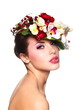 beautiful woman with bright makeup with colorful flowers on head