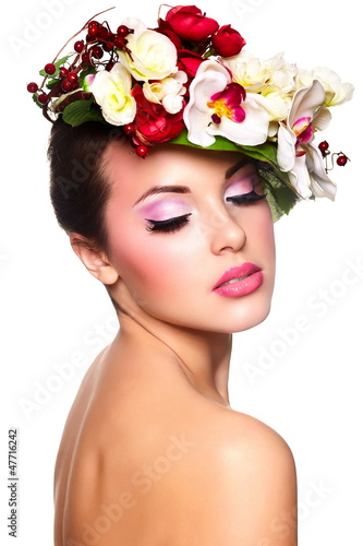 Photo: beautiful woman with bright makeup with colorful flowers on head beautiful woman with bright makeup with colorful flowers on head