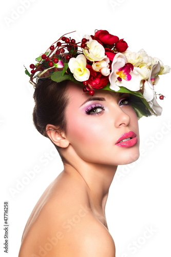 Photo: beautiful woman with bright makeup with colorful flowers on head beautiful woman with bright makeup with colorful flowers on head
