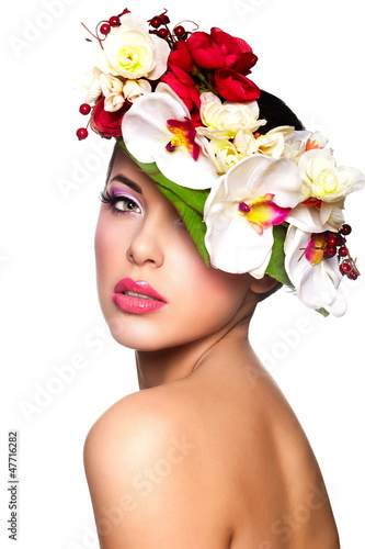 Photo: beautiful woman with bright makeup with colorful flowers on head beautiful woman with bright makeup with colorful flowers on head