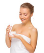 Young healthy woman with body cream