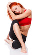 slim redhead girl sitting on white floor