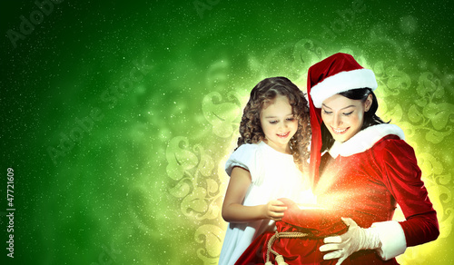 Photo: Little girl with christmas gifts and santa Little girl with christmas gifts and santa