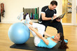 Personal trainer instructing woman in gymnastics