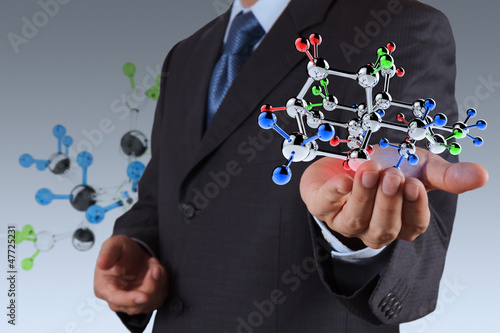 Photo: businessman holding a molecule businessman holding a molecule