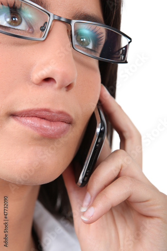 Photo: Woman wearing glasses on the phone Woman wearing glasses on the phone