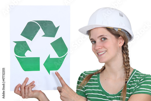 Photo: Craftswoman displaying recycling sign Craftswoman displaying recycling sign