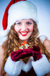 Beautiful woman in a red dress and hat of Santa with a christmas