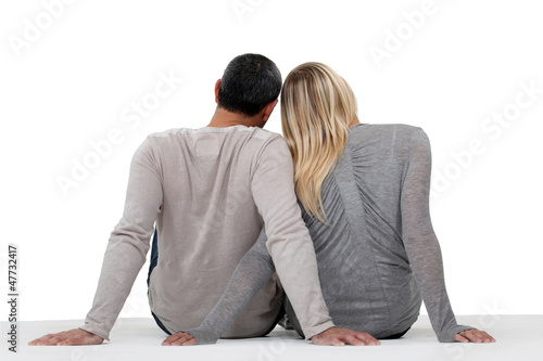 Photo: couple turned back beholding sunset on beach couple turned back beholding sunset on beach