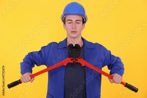 Photo: Builder using bolt cutters Builder using bolt cutters