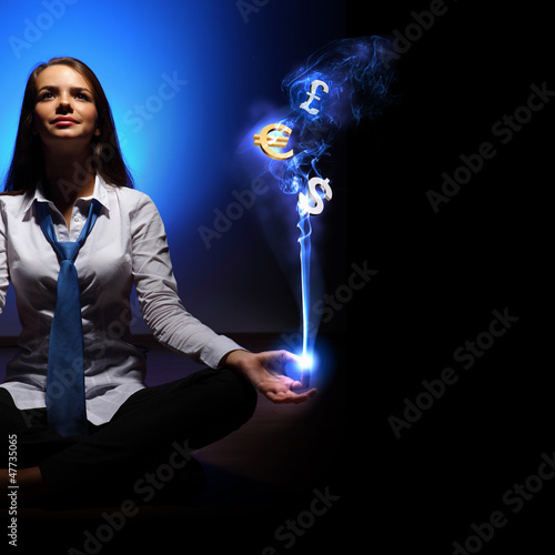 Photo: Business woman with financial symbols around Business woman with financial symbols around
