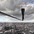 Balancing businesswoman and cityscape