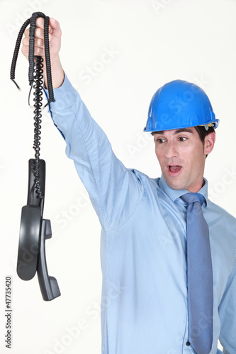 Photo: An architect holding a bunch of broke phones. An architect holding a bunch of broke phones.