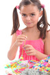 Photo: Little girl making necklace Little girl making necklace
