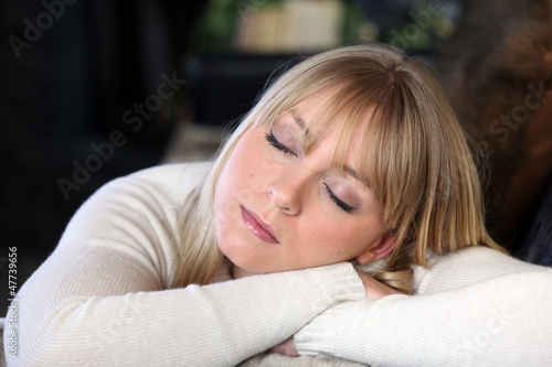Photo: Blond woman snoozing Blond woman snoozing