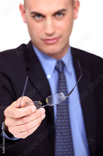 Photo: Businessman offering his glasses Businessman offering his glasses