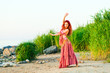 girl in east dress on seacoast before a sunset