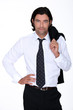 Good looking man in a suit holding his jacket over his shoulder