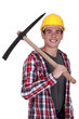 Smiling young man with a pickaxe