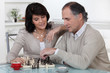 Middle-aged couple playing chess