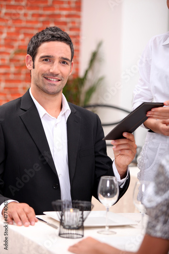 Photo: businessman eating in a restaurant businessman eating in a restaurant