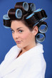 woman in bath robe and curlers in her hair