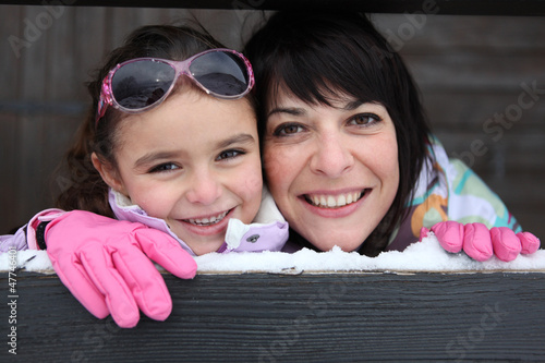 Photo: Mother and daughter stood by their ski house Mother and daughter stood by their ski house