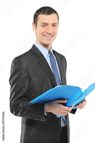 Photo: A smiling businessman holding a document A smiling businessman holding a document