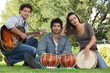 three musicians in a park
