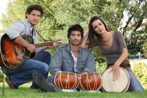 Photo: three musicians in a park three musicians in a park