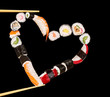 Sushi sticks holding pieces of sushi in heart shape